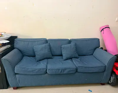 Comfortable blue 3-seater sofa with matching pillows