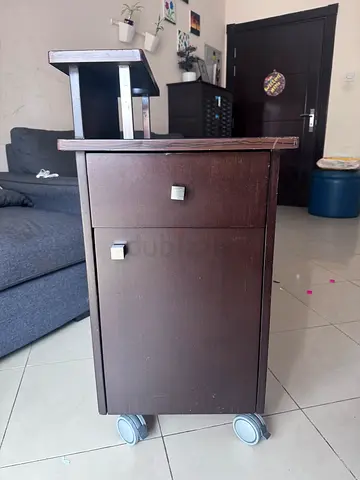Small dark wood storage cabinet on wheels - good condition