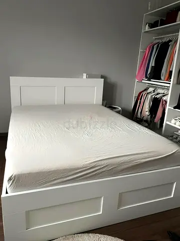 White wooden double bed frame with headboard and storage-style panels