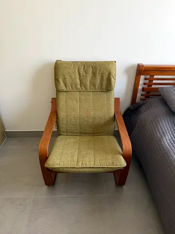 Used green cushioned lounge armchair with pure wooden frame