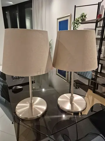 Pair of modern brushed steel table lamps with beige fabric shades