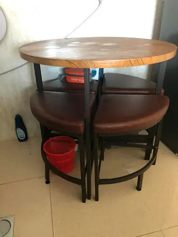 Compact round wooden dining table with 4 tuck-away stools