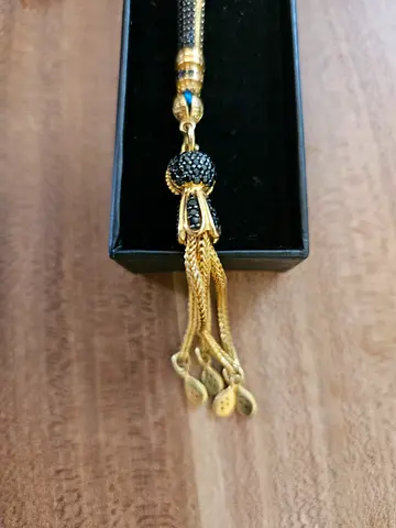 Elegant luxury tasbih featuring beautifully faceted smoky-grey crystal beads with gold-tone  black