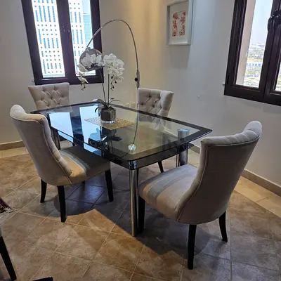 A glass dinning table with 4 chairs