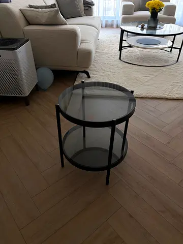 Round glass top side table with black metal frame