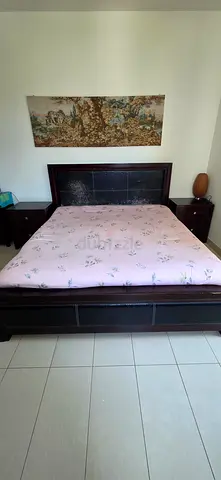 King wooden bed frame with mattress and bedside tables.Chest of drawer dresser included with mirror