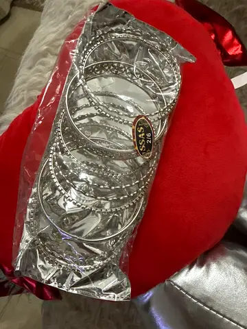 Set of silver colored bangles in original packaging