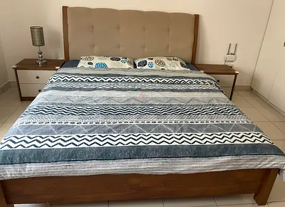 King size wooden bed frame with upholstered headboard and two bedside tables