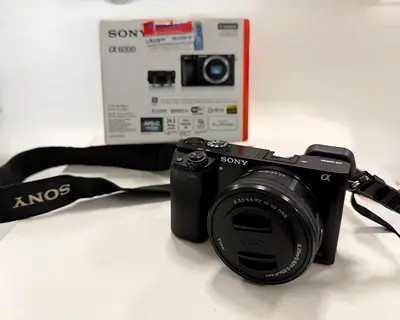 Sony Alpha a6000 mirrorless camera with 16-50mm kit lens and strap