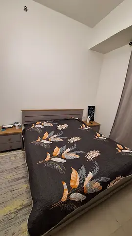 Grey wooden double bed with two matching bedside tables