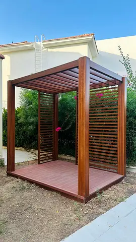 Wooden pergola/gazebo structure — modern slatted design, good condition