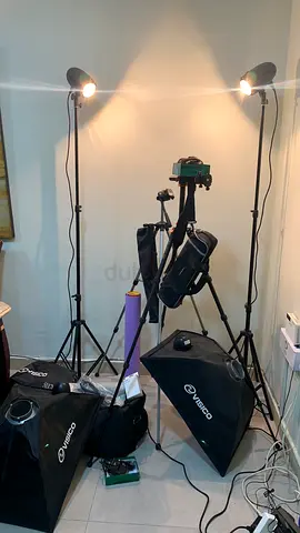 studio lighting kit includes soft light boxes, stands, lamps, a carrying case, as well as a camera t