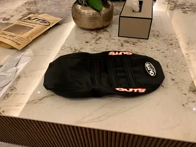 Black GUTS seat cover for Surron lbx