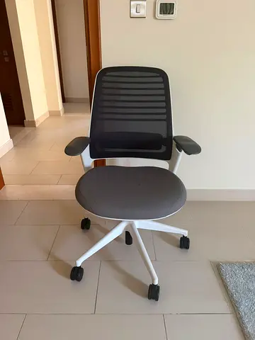 SteelCase grey mesh ergonomic office chair with armrests and wheels