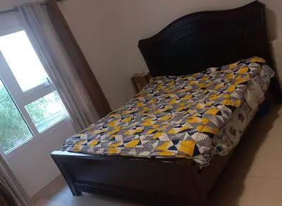 Queen-size wooden bed frame with headboard and NO mattress
