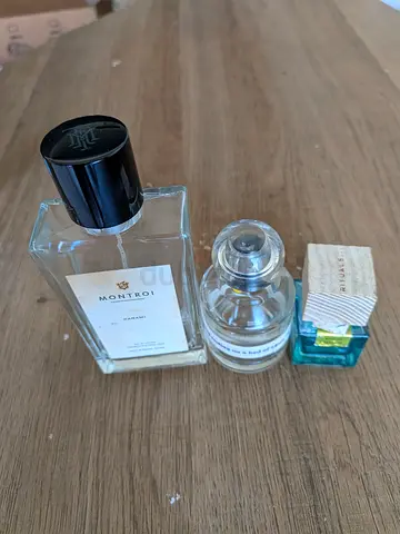 Three empty glass perfume bottles — Montroi,  Other Stories and Ritual pocket size