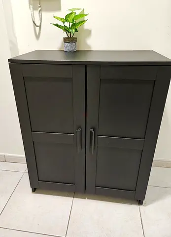 Compact black cabinet with double doors — good condition