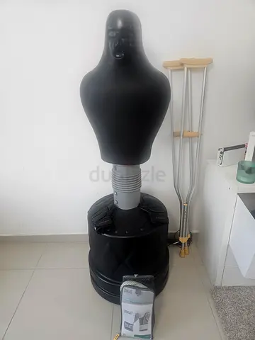 Adjustable boxing dummy with MMA gloves and boxing gloves