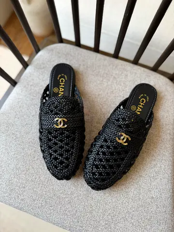 Chanel sandals feature black woven raffia