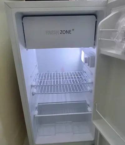 Single-door refrigerator in working condition — compact fridge with freezer compartment