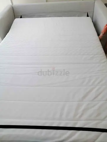 Beige colour  2-seater sofa bed in good condition
