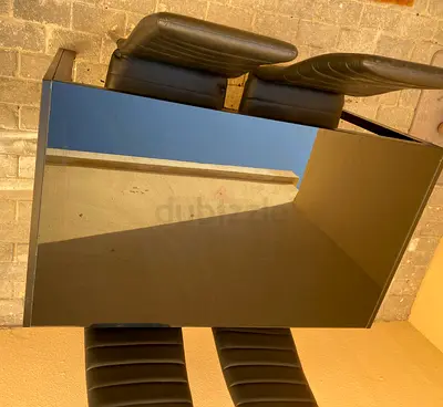Black glass dining table with 4 padded chairs