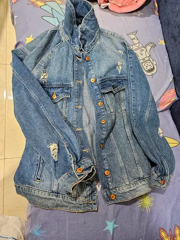 Fashionably ragged blue denim jacket, size XL