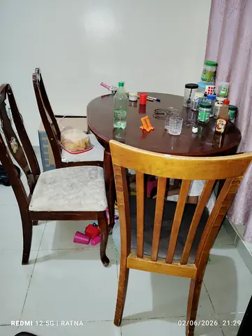 Wooden dining table for sale with three wooden chairs