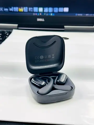 Used Huawei FreeBuds or similar true wireless earphones with charging case - good condition