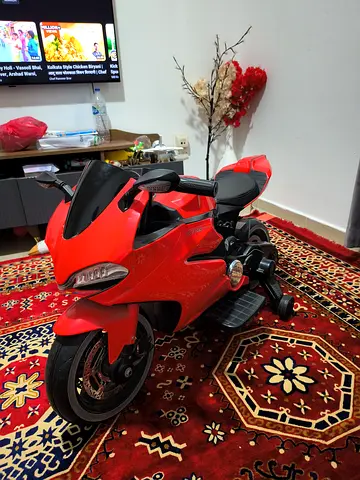 Red electric ride-on motorcycle for kids (good working condition)