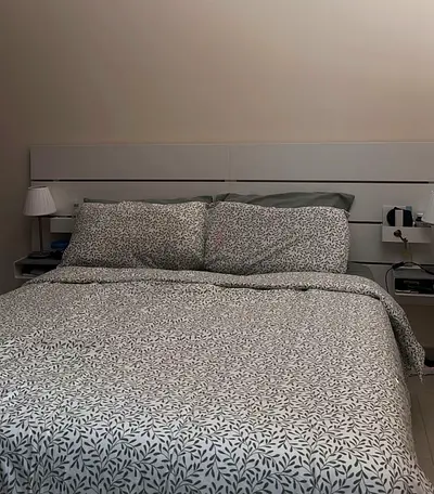 White bed with frame and attachable side tables