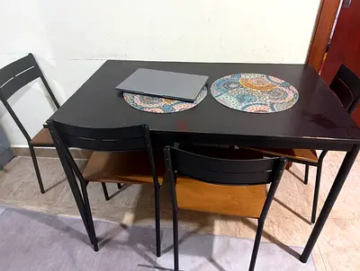 Small black dining table with 4 matching chairs - compact set