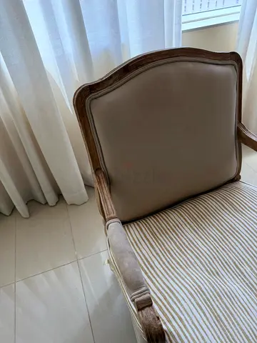 Vintage wooden framed armchair with neutral upholstery
