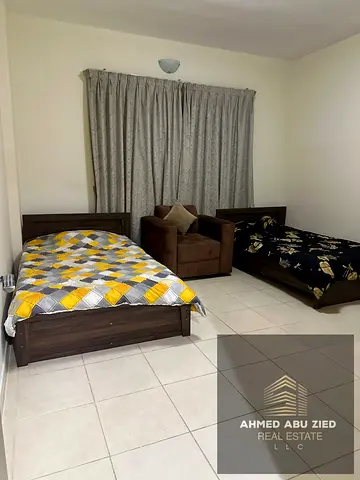 For annual rent, a furnished two-bedroom apartment with a living room in Orient Towers – Al Mina Street, very prime location, spacious area, and clean