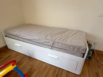 White single daybed with storage drawers and mattress