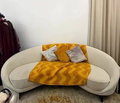 Curved Cream Three-Seater Sofa with Mid-Century Legs from The One Furniture companys