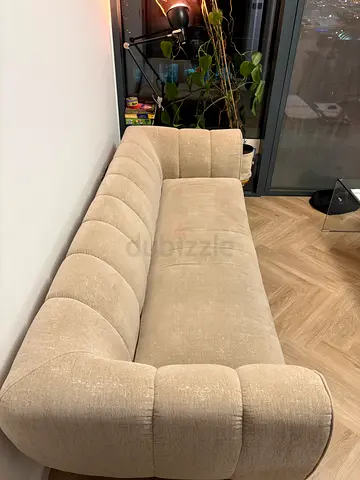 Three-seater beige upholstered sofa in good condition