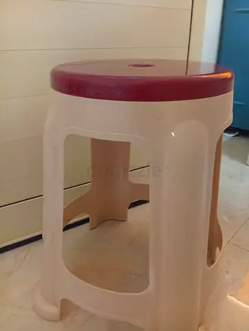 Simple plastic round stool — light beige with maroon seat