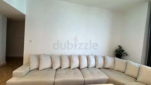 Light beige L-shaped sectional sofa with cushions