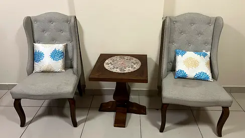 Pair of grey wingback chairs with side table