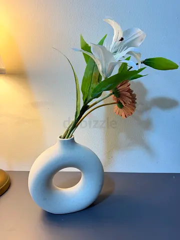 White donut ceramic vase with faux flowers