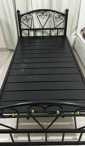 Single black metal bed frame with decorative headboard and footboard