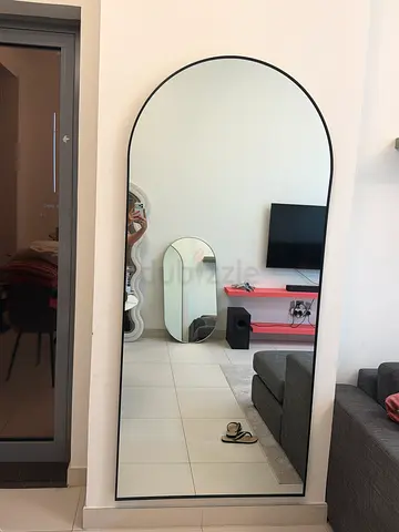 Round mirror with black metal accents