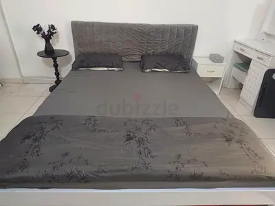 Ikea wooden bed with mattress and grey headboard cover