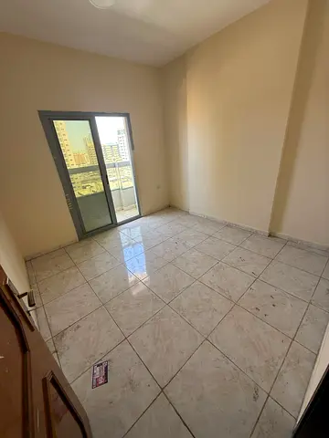 For rent in Al Nuaimiya 1, 2-bedroom apartment with living room, 2 bathrooms and 2 balconies. Near Al Hikma School. AED 33,000 yearly, 4 payments, sec