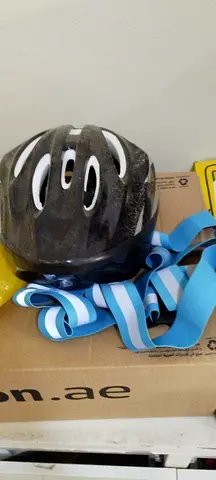 Black cycling helmet with reflective straps
