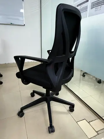 Black ergonomic office chair with mesh back — good condition