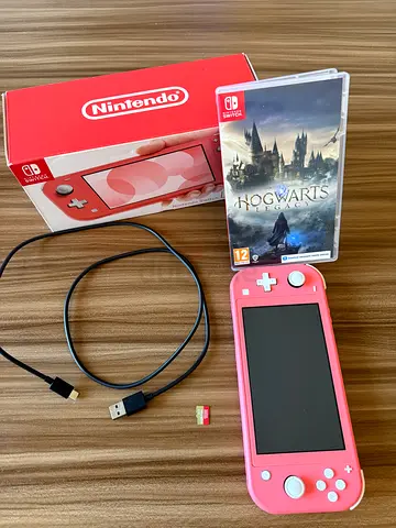 Pink Nintendo Switch Lite console with Hogwarts Legacy cartridge and original box, charger and sd
