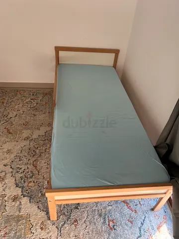 Single wooden bed frame in light wood - good condition