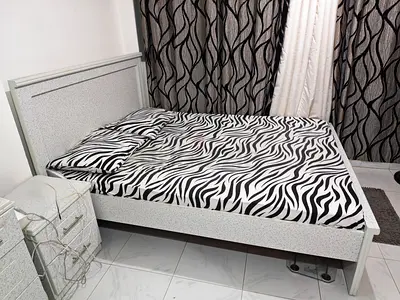 Gray patterned queen size bed frame and mattress in very good condition